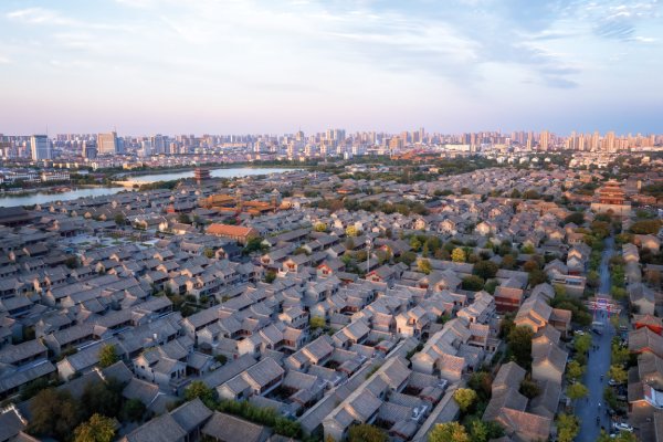 pipeline An aerial view shows a densely populated urban area filled with homes, tall buildings, and vegetation.