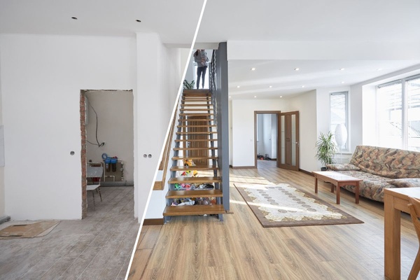 A living room with a couch and half the room under renovation and a woman holding a child on top of staircase.